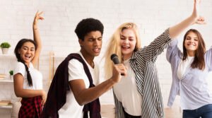 birthday-party-ideas-teen-friends-having-party-and-singing-karaoke